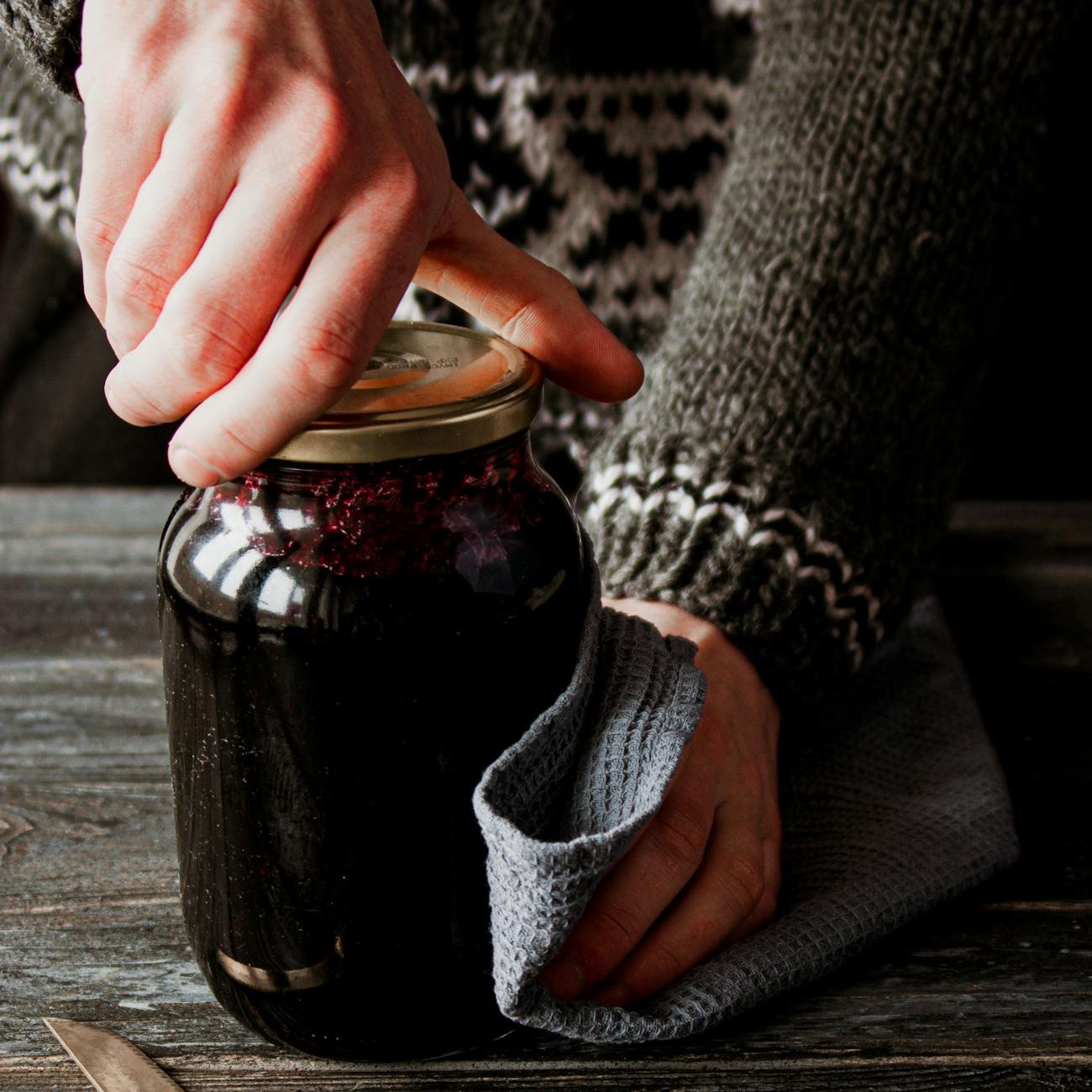 person opening the glass jar